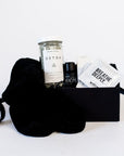 Black chenille socks, Herbivore detox bath salts, vitruvi eucalyptus essential oil, Spritz breathe deeply set of three wipes in a black box.