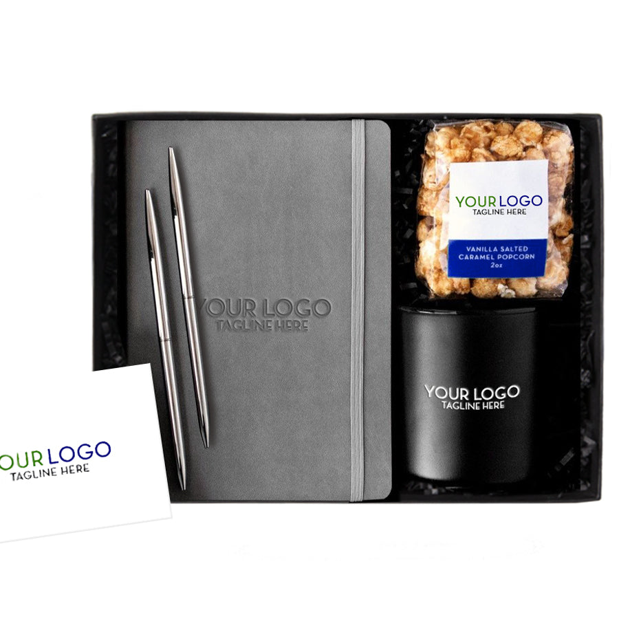 White custom logo card, black custom branded notebook with strap, set of two black metal pens, black custom branded camp travel mug, 2 oz vanilla salted caramel popcorn with custom logo. All in black gifting box with black paper shred