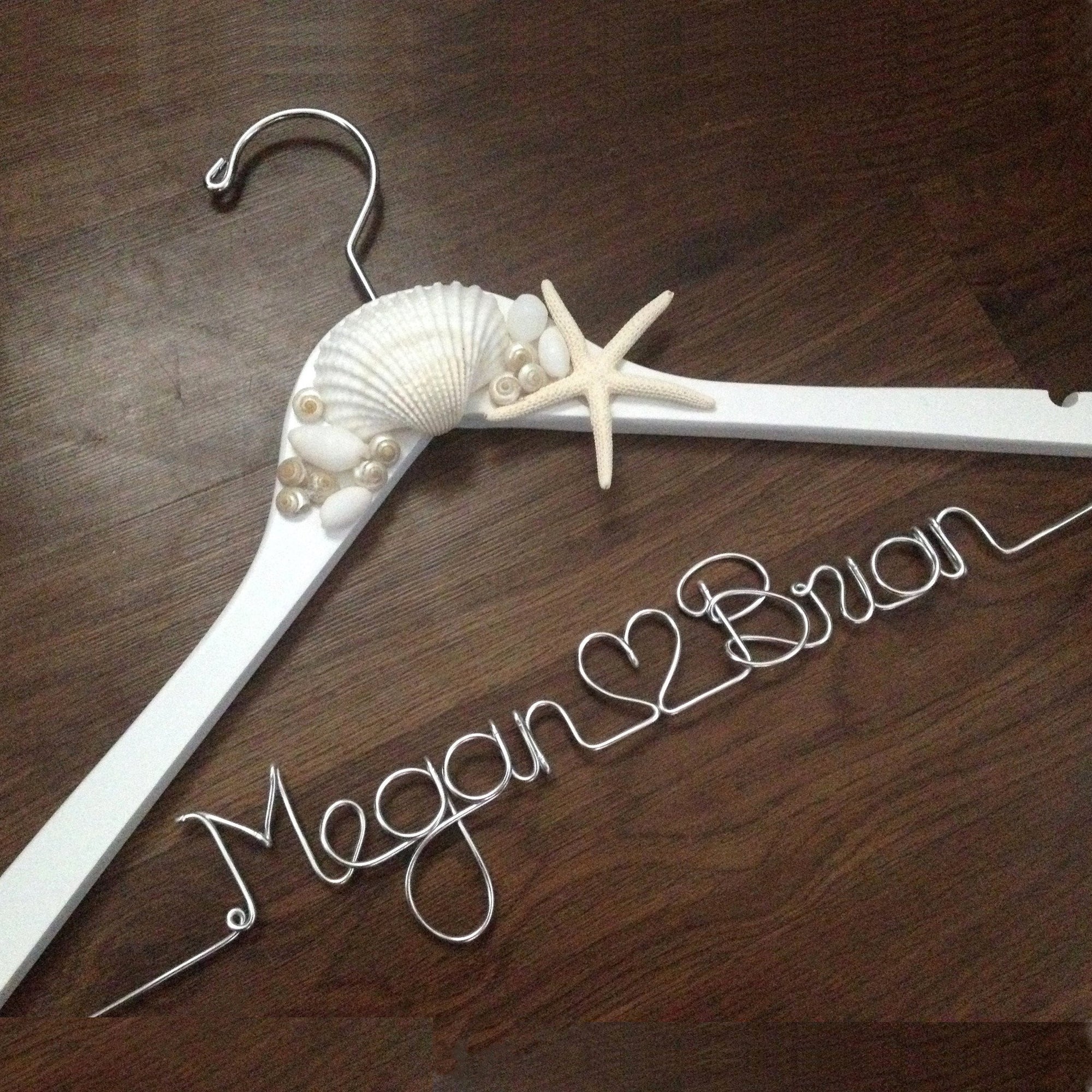 White hanger with shells and starfish accents. Personalized handcrafted wire hanger base