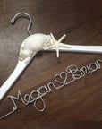 White hanger with shells and starfish accents. Personalized handcrafted wire hanger base