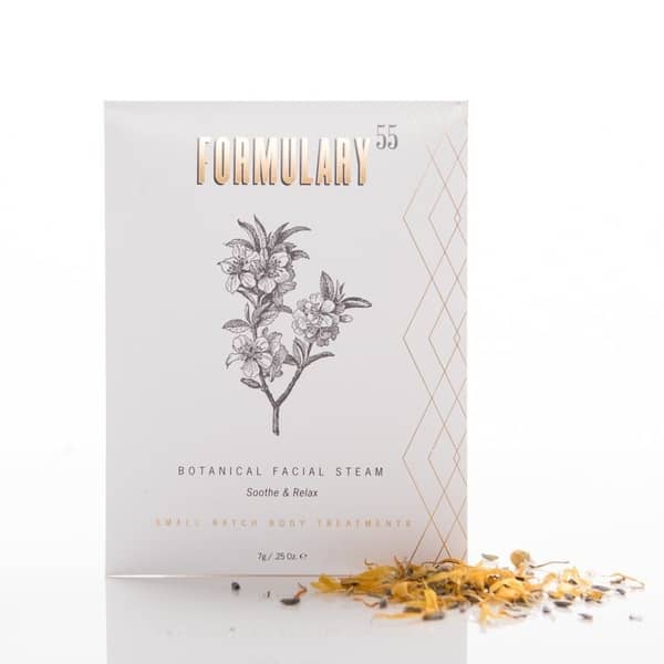 single use, .25 oz formulary55 botanical facial steam packet, with a small pile of flower petals, black and gold text, with a black flower graphic. 