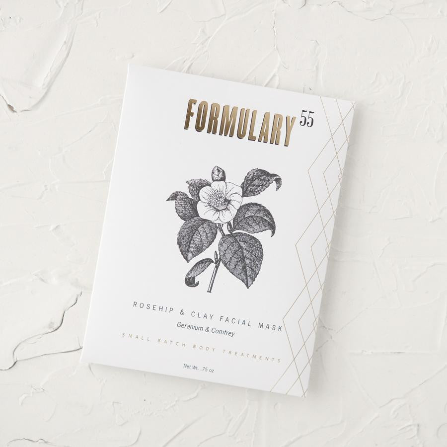 Rosehip + Clay Facial Mask in a .75 oz white packet. with black and gold text, with a black flower graphics.