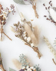 multiple dried floral bundles spaced out shown on white background