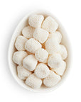 Small white ovular dish containing white gummy drops covered in white nonpareils.