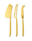 A Gold cleaver cheese knife next to a gold perforated, fork tipped cheese knife next to a fork tip spear cheese knife